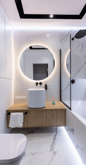 Bathroom with Lighting Around Mirror and On Walls
